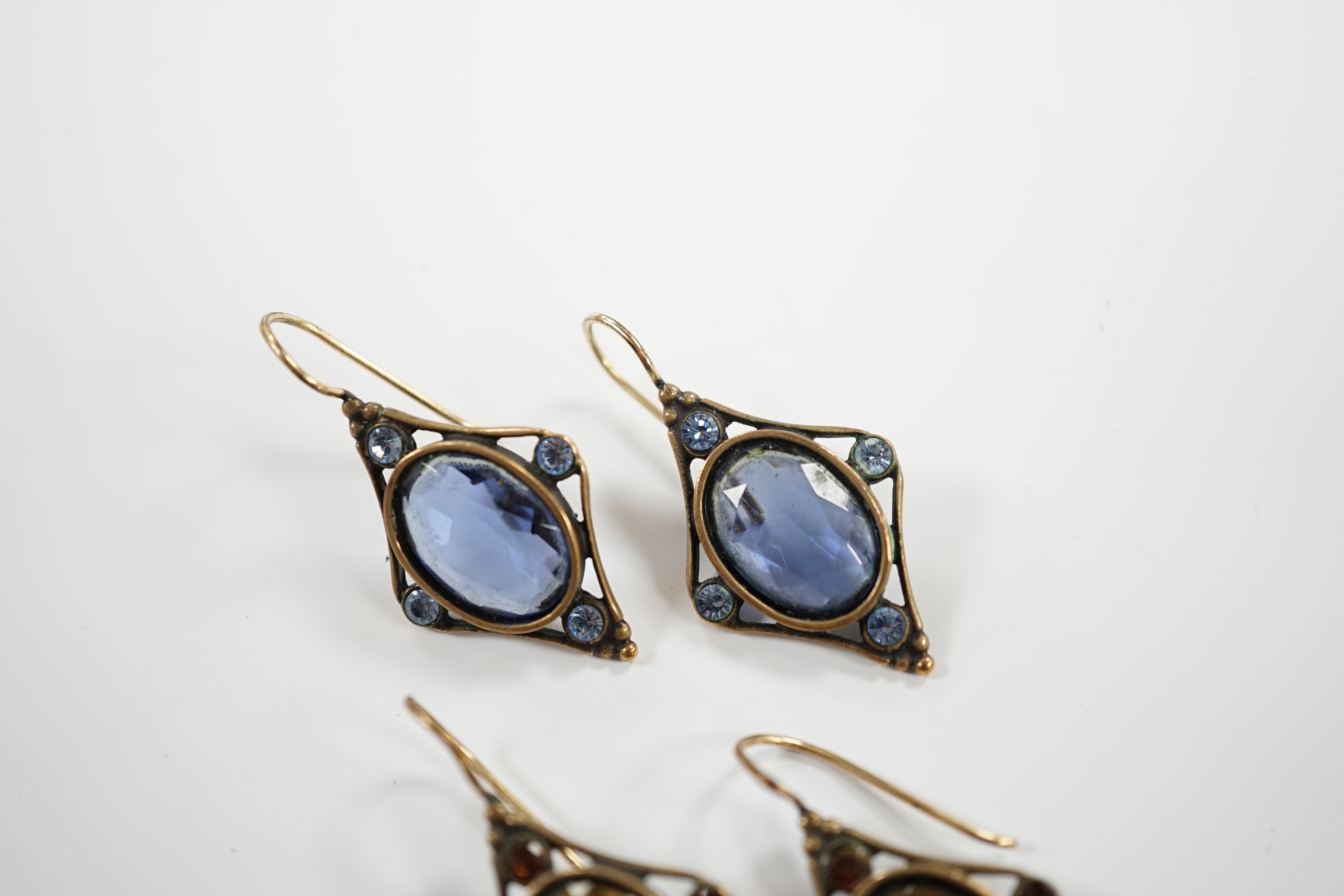 Two pairs of early 20th century gilt metal and coloured paste set drop earrings, overall 37mm.